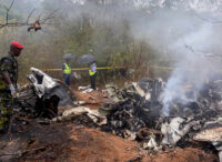 Kenyan security officials secure the wreckage of an aircraft which crashed with 11 people onboard.