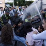 Members of the security forces detain a protester as others scuffle during a youth-led demonstration in Rabat on 29 September 2025, calling for reforms in the public health and education sectors. AFP - ABDEL MAJID BZIOUAT