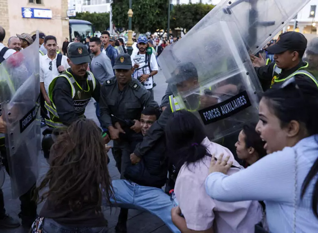 Members of the security forces detain a protester as others scuffle during a youth-led demonstration in Rabat on 29 September 2025, calling for reforms in the public health and education sectors. AFP - ABDEL MAJID BZIOUAT