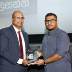 Journalist Kasun Pussewela presenting CIABOC DG Ranga Dissanayake a copy of the Sinhala translation of ‘Unbowed & Unafraid’